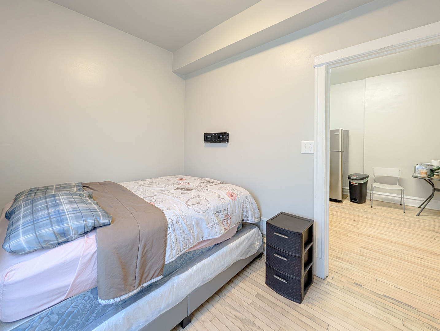 2838 West Roosevelt Road, Unit 3R Chicago, IL 60612 - Photo 15 of 23 a bedroom with a bed and wooden floor