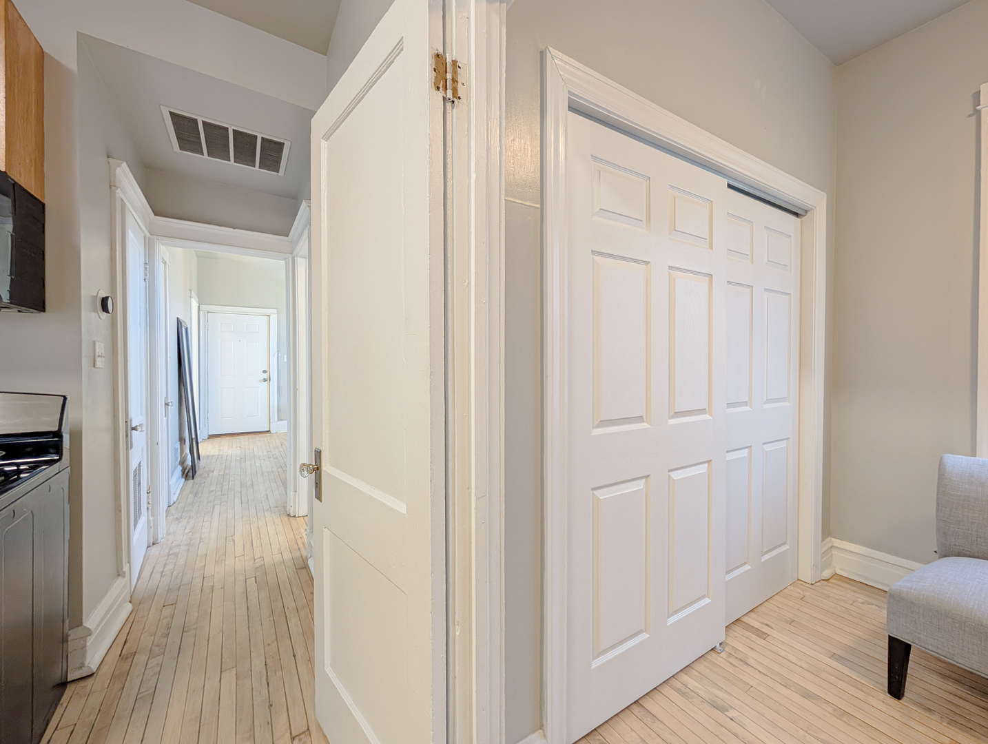 2838 West Roosevelt Road, Unit 3R Chicago, IL 60612 - Photo 6 of 23 a view of a hallway with wooden floor and closet area
