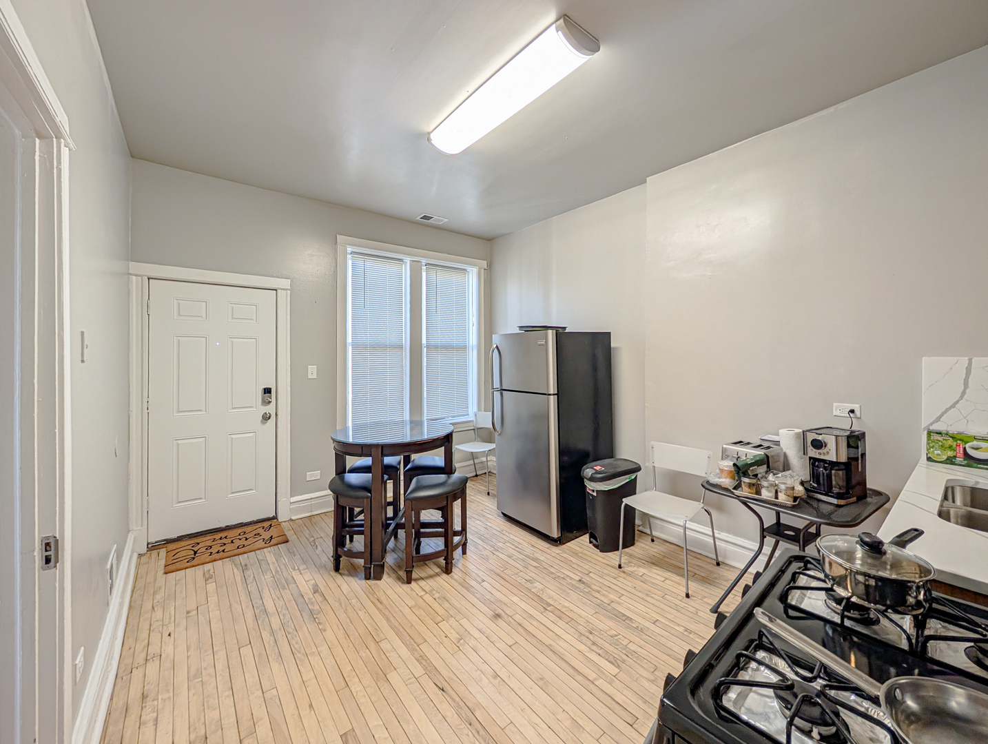 2838 West Roosevelt Road, Unit 3R Chicago, IL 60612 - Photo 7 of 23 a dining room with furniture and wooden floor