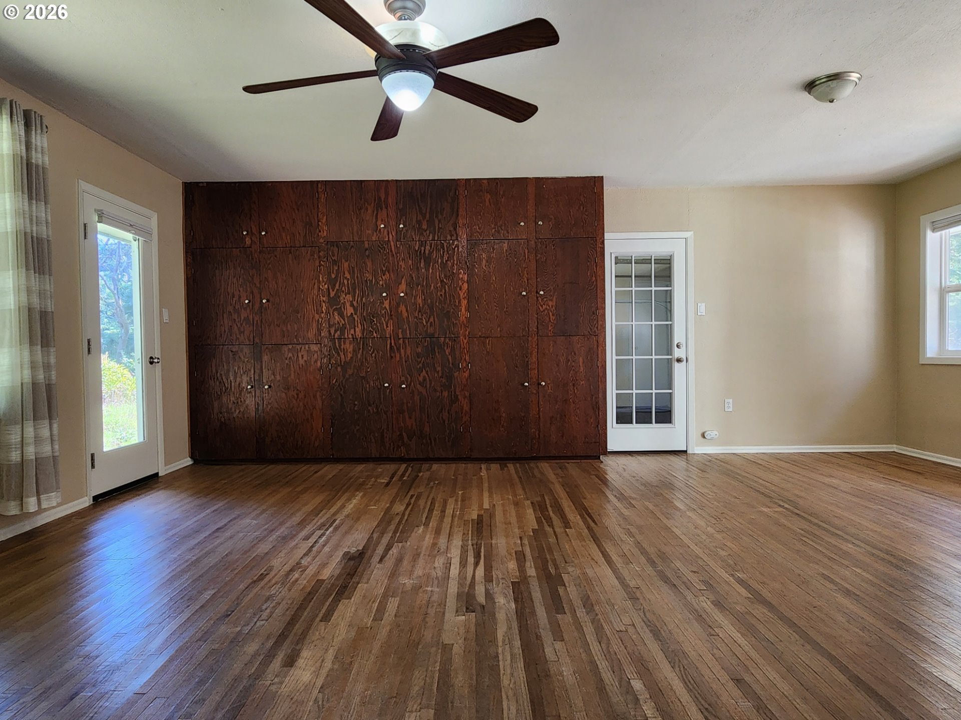 92504 Paradise Point Road Port Orford, OR 97465 - Photo 12 of 39 an empty room with wooden floor closet and windows