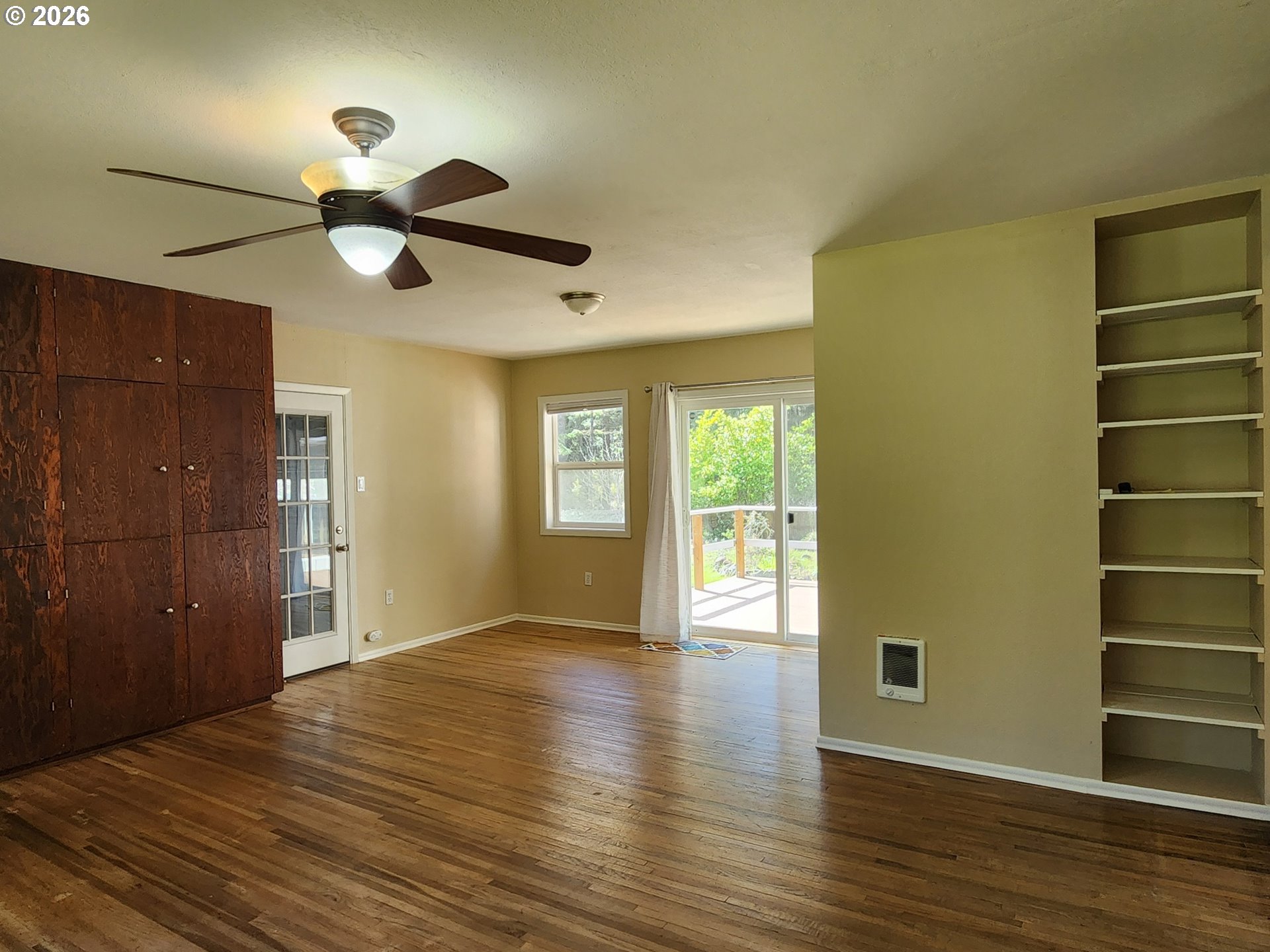 92504 Paradise Point Road Port Orford, OR 97465 - Photo 13 of 39 a view of an empty room with a window and wooden floor