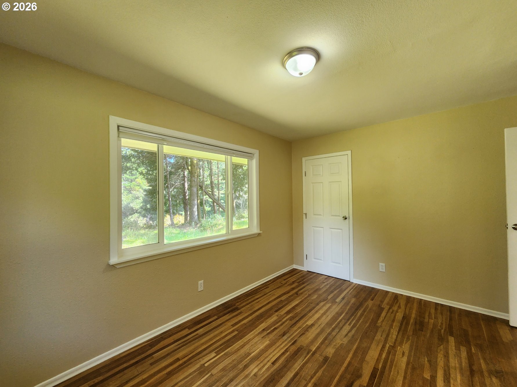92504 Paradise Point Road Port Orford, OR 97465 - Photo 19 of 39 a view of a room with wooden floor and fan
