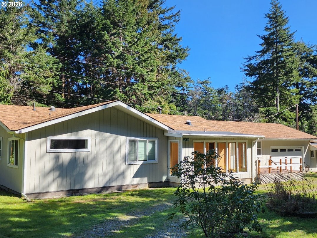 92504 Paradise Point Road Port Orford, OR 97465 - Photo 2 of 39 a view of a house with a yard and plants