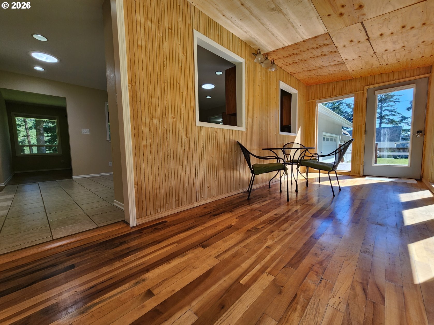 92504 Paradise Point Road Port Orford, OR 97465 - Photo 26 of 39 a view of a patio with table and chairs with wooden floor