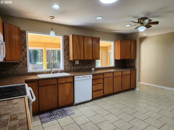 a kitchen with a sink window and cabinets