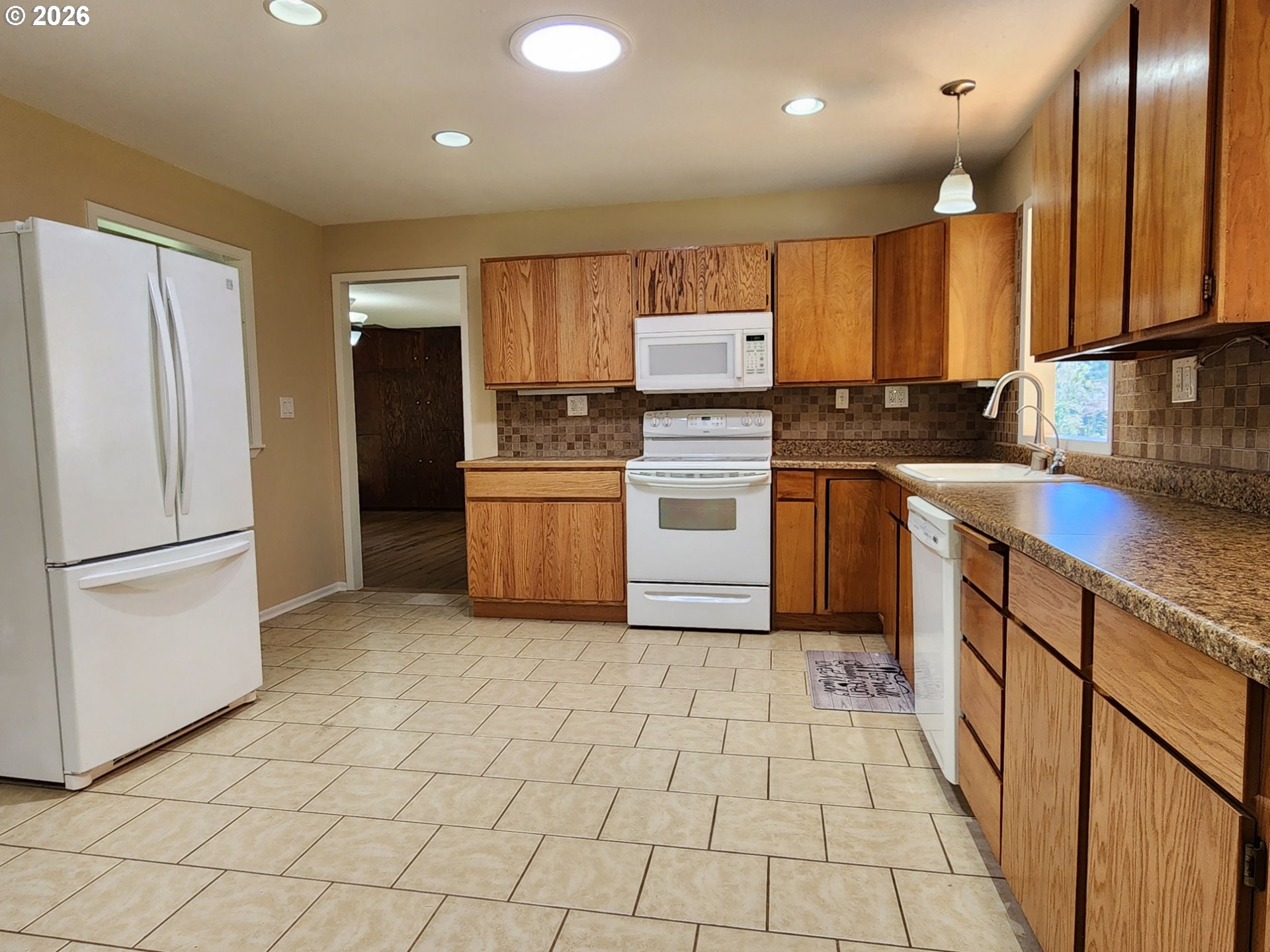 92504 Paradise Point Road Port Orford, OR 97465 - Photo 7 of 39 a kitchen with stainless steel appliances a refrigerator sink and microwave
