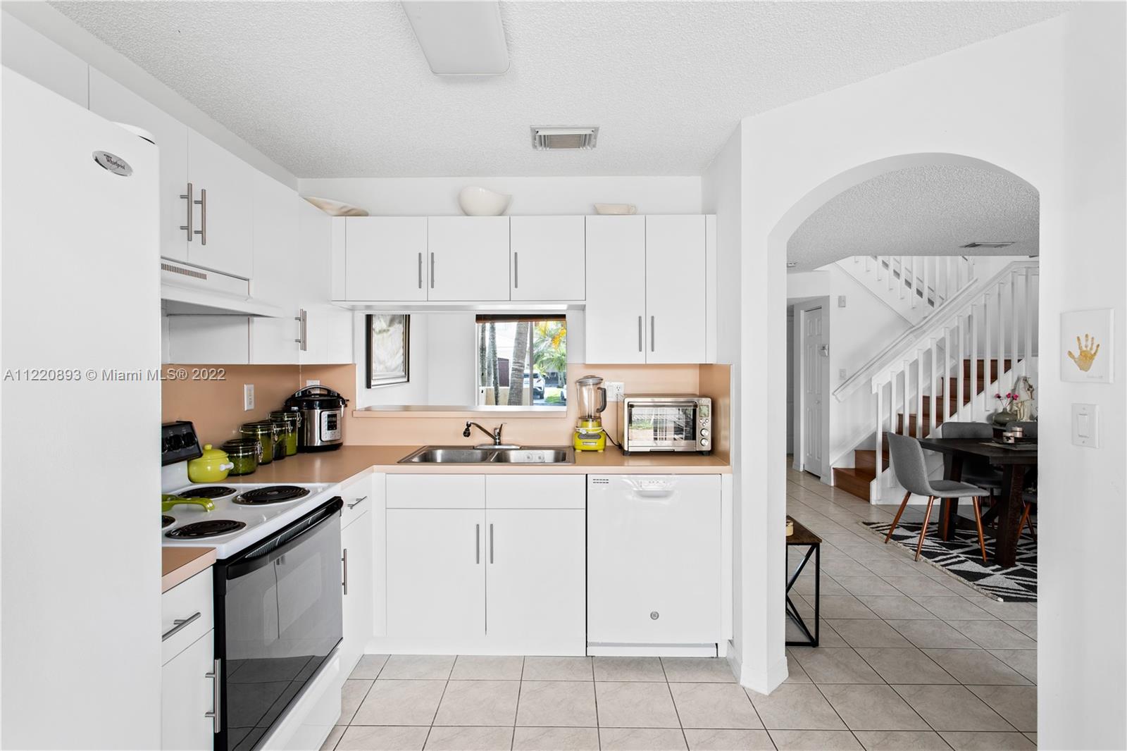 West Kendall Miami, FL 33193 - Photo 11 of 33 a kitchen with a sink a stove and cabinets