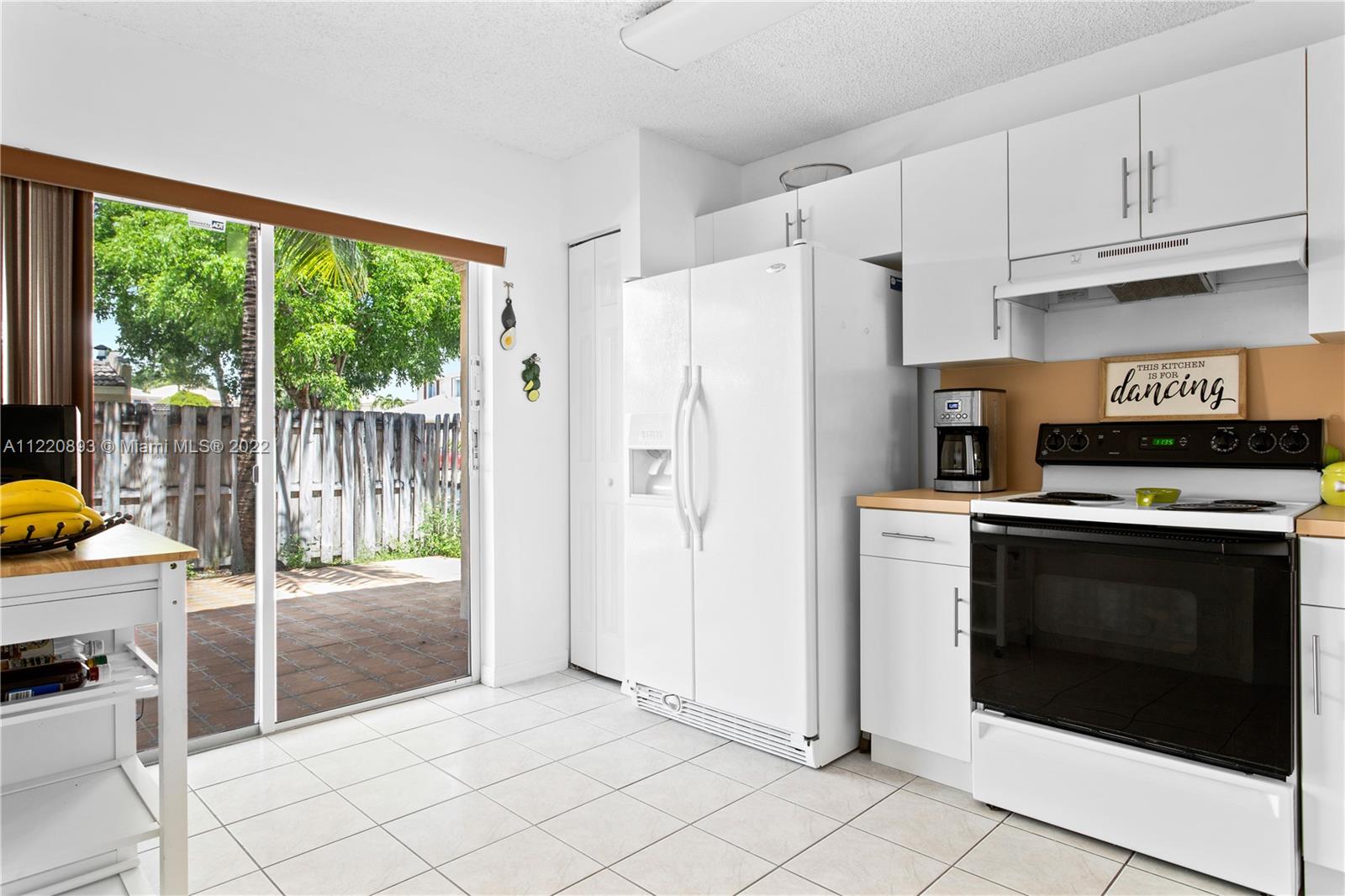 West Kendall Miami, FL 33193 - Photo 12 of 33 a kitchen with granite countertop a refrigerator and a stove