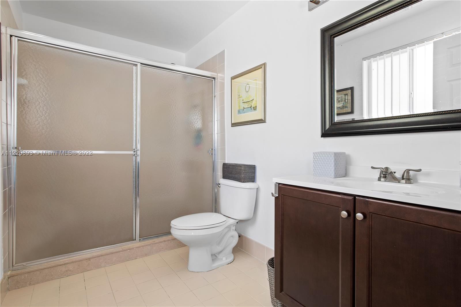 West Kendall Miami, FL 33193 - Photo 19 of 33 a bathroom with a sink a toilet and a mirror