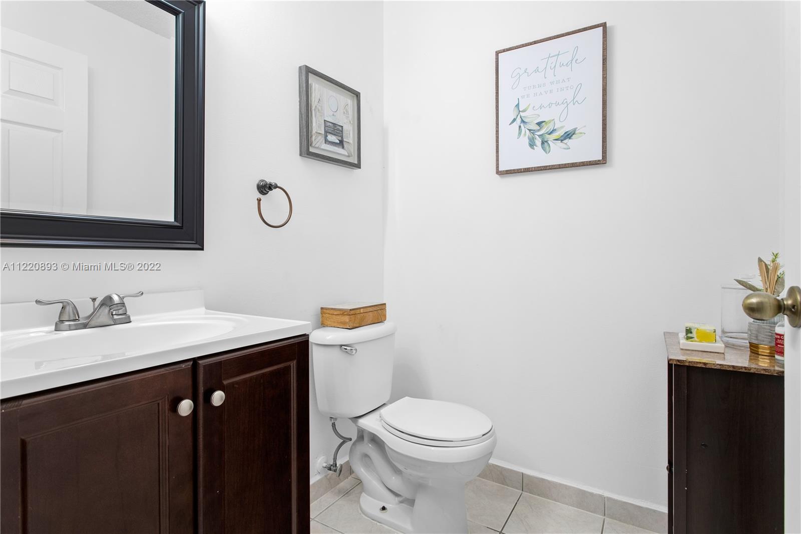 West Kendall Miami, FL 33193 - Photo 9 of 33 a bathroom with a toilet sink and mirror