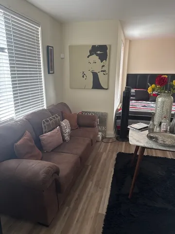 a living room with furniture and wooden floor