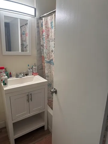 a bathroom with a sink vanity and a mirror
