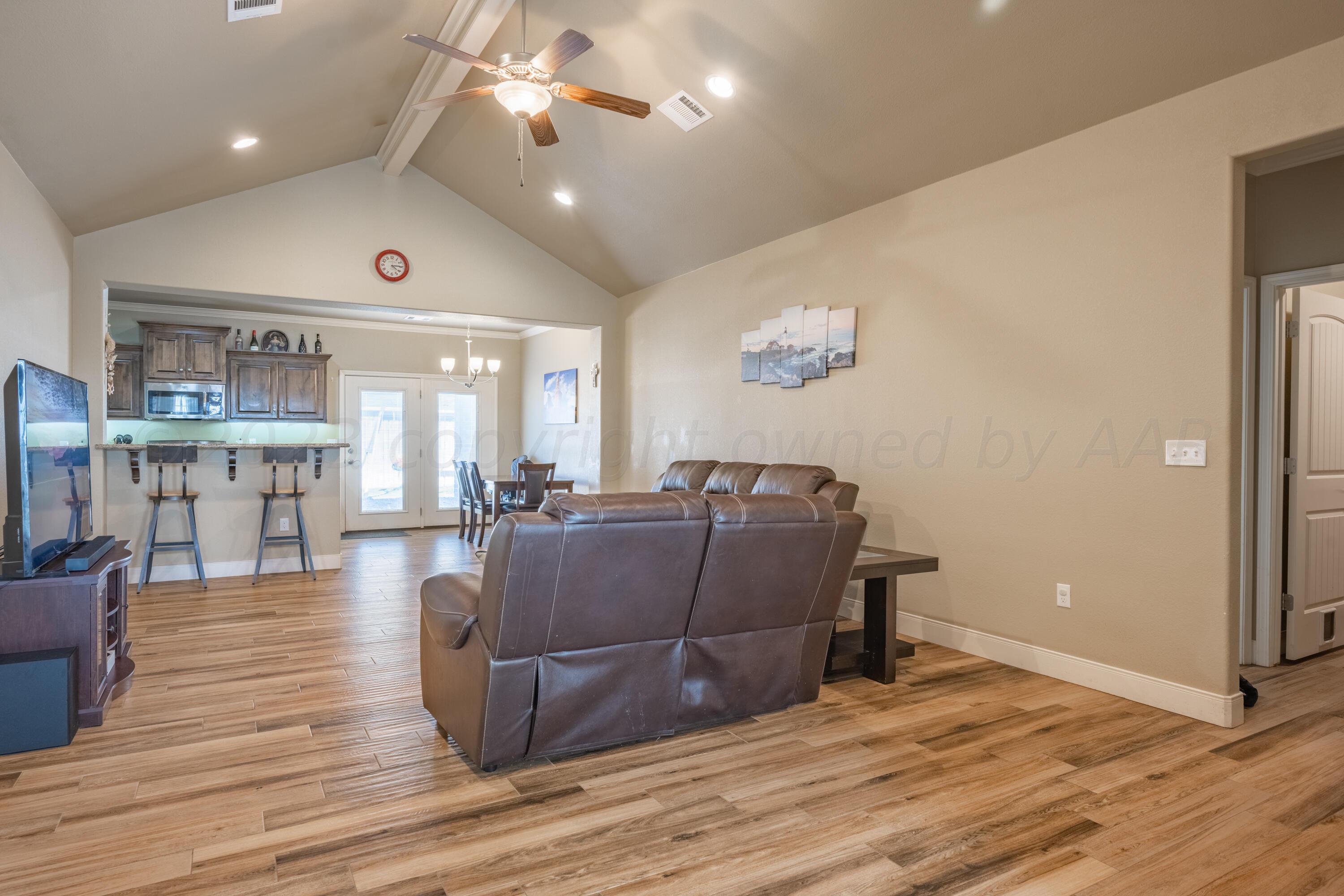 4910 Hicks Street Amarillo, TX 79118 - Photo 3 of 19 a living room with furniture and a wooden floor