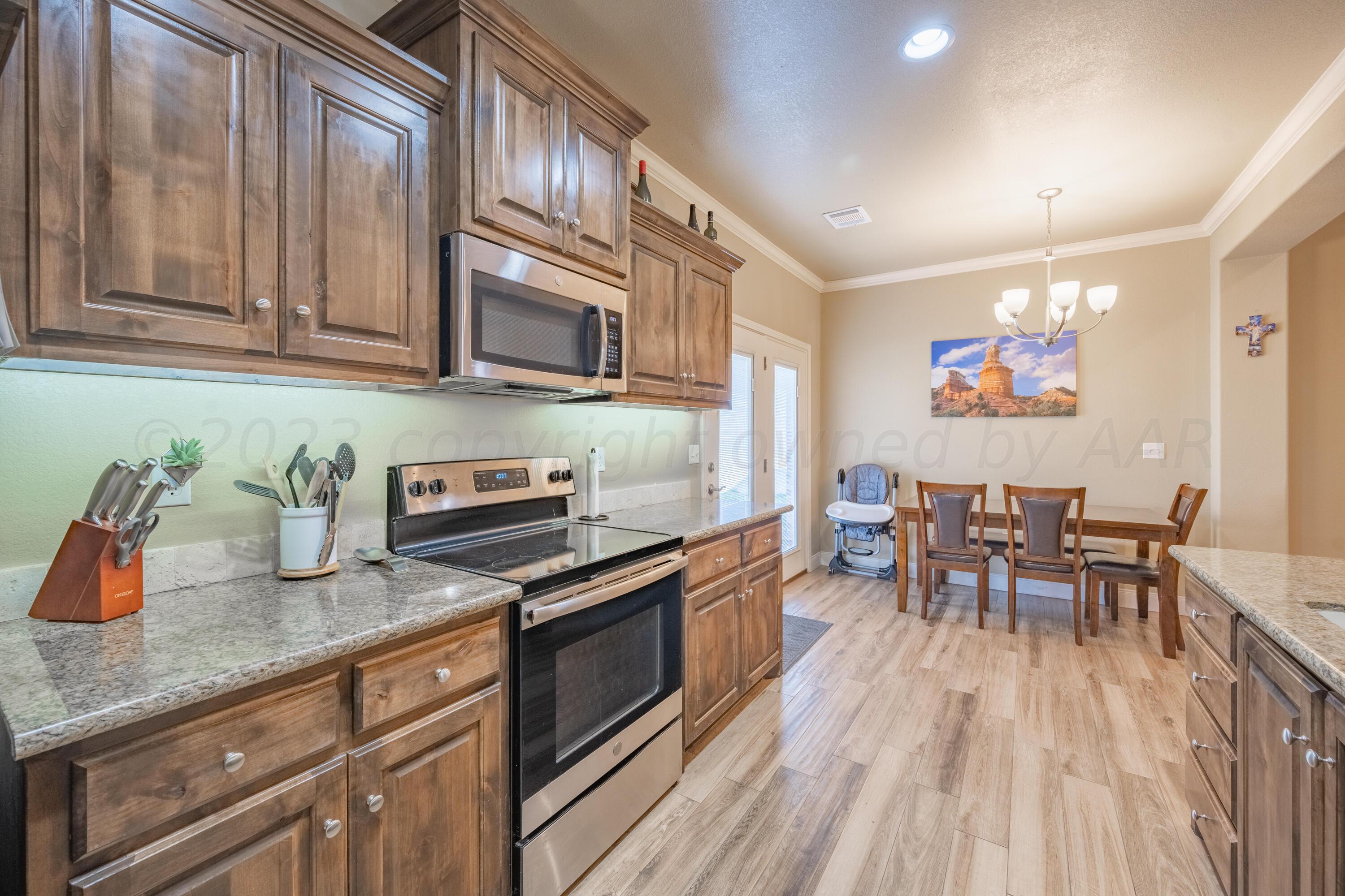 4910 Hicks Street Amarillo, TX 79118 - Photo 6 of 19 a kitchen with granite countertop lots of counter top space and dining table