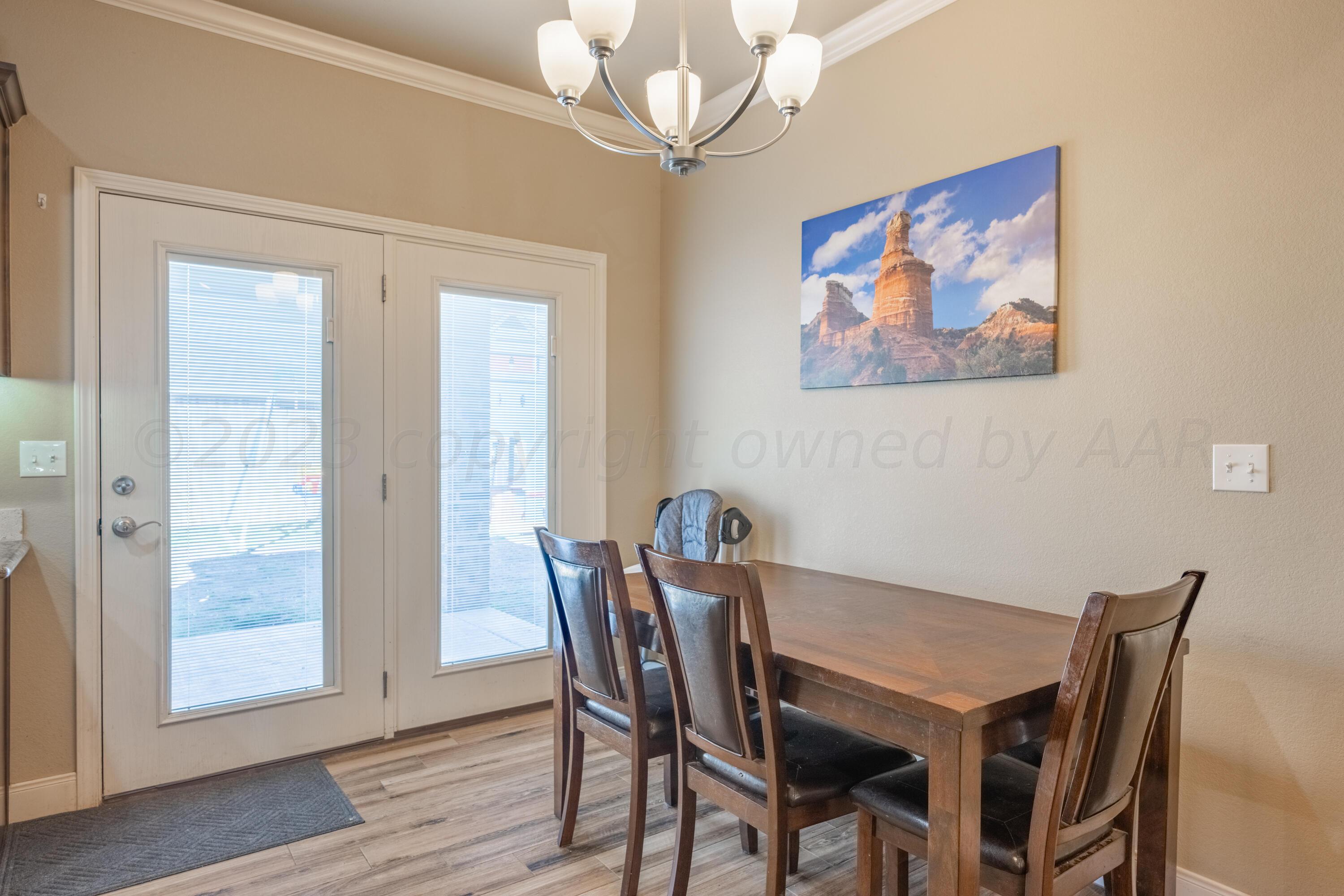 4910 Hicks Street Amarillo, TX 79118 - Photo 8 of 19 a view of a dining room with furniture wooden floor and a chandelier
