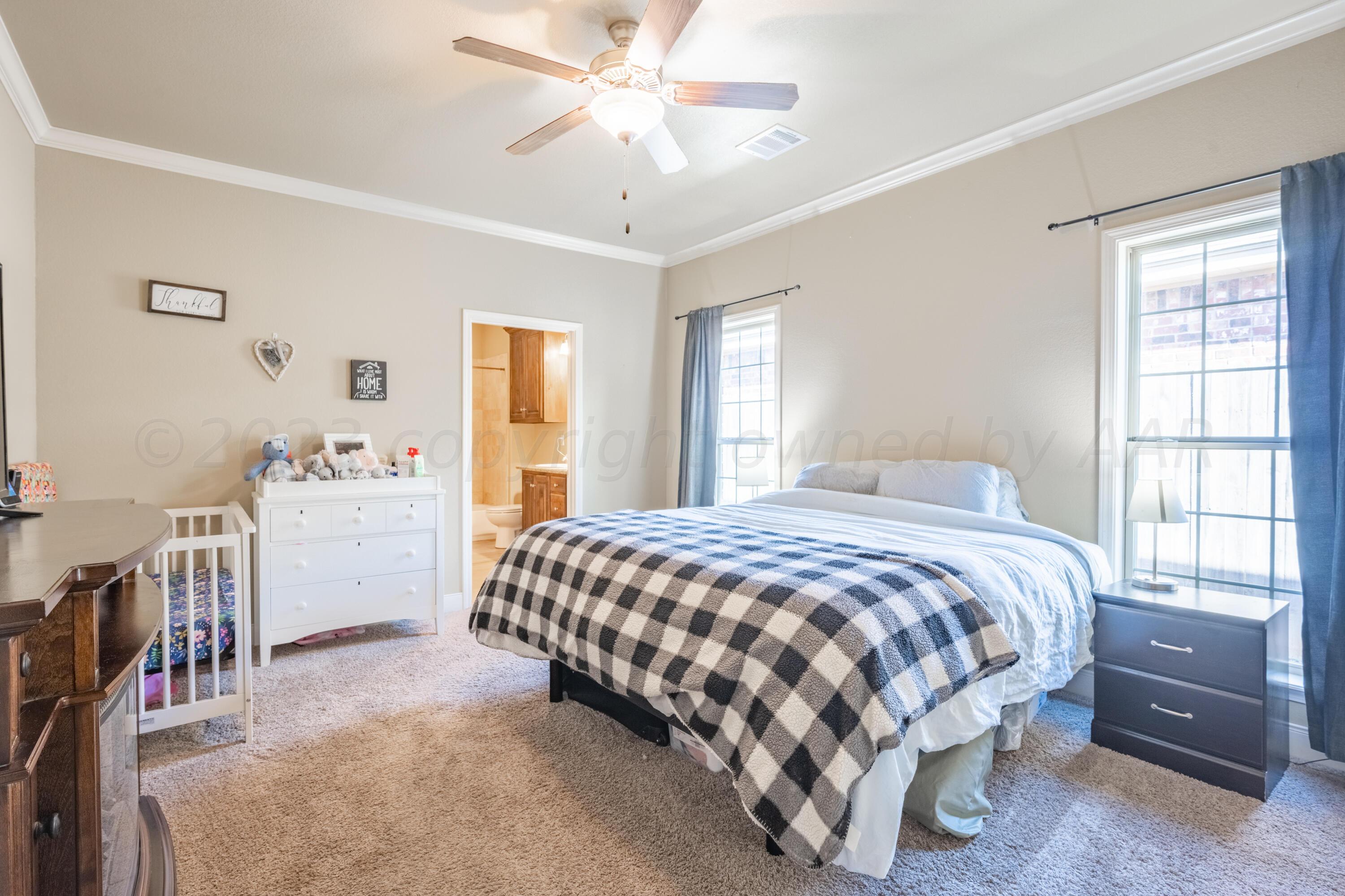 4910 Hicks Street Amarillo, TX 79118 - Photo 9 of 19 a bedroom with a bed and a window