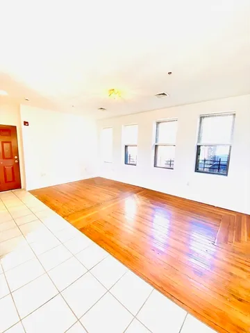 a view of an empty room and wooden floor