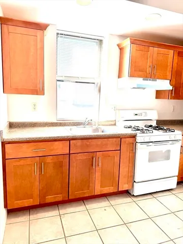 a kitchen with granite countertop cabinets and windows