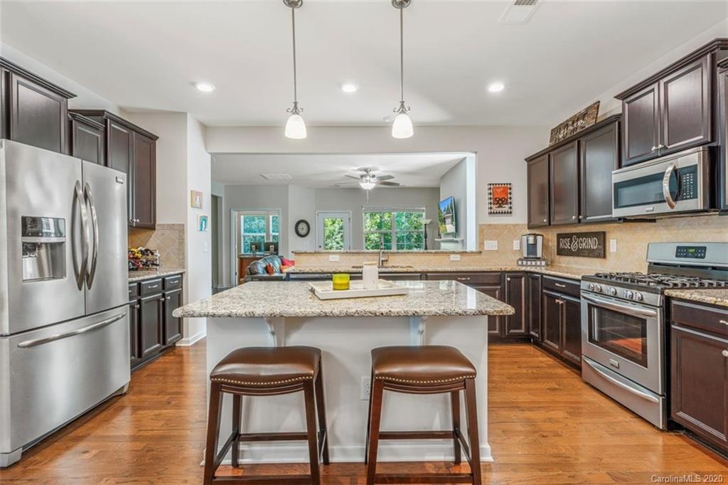 4303 Perth Road Indian Land, SC 29707 - Photo 12 of 32 a kitchen with kitchen island a large counter top space appliances and cabinets