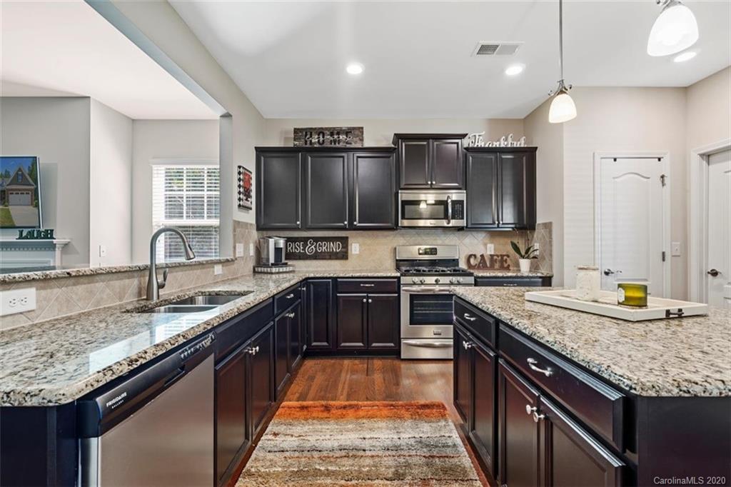 4303 Perth Road Indian Land, SC 29707 - Photo 16 of 32 a large kitchen with stainless steel appliances granite countertop a sink stove and refrigerator