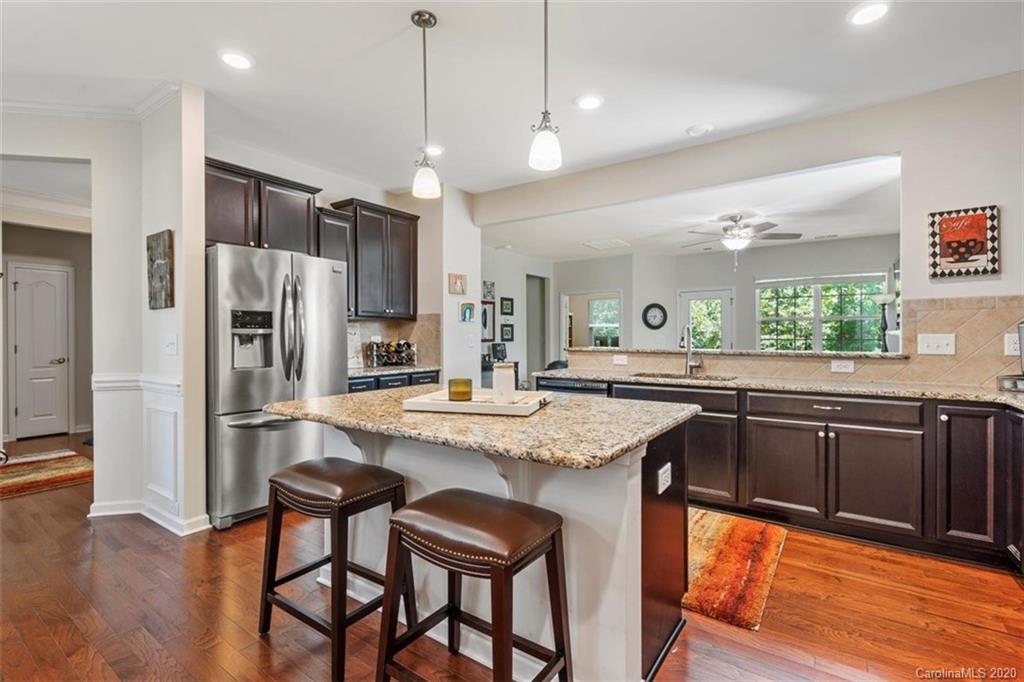 4303 Perth Road Indian Land, SC 29707 - Photo 20 of 32 a kitchen with stainless steel appliances granite countertop a refrigerator a sink dishwasher a stove and white countertops with wooden floor