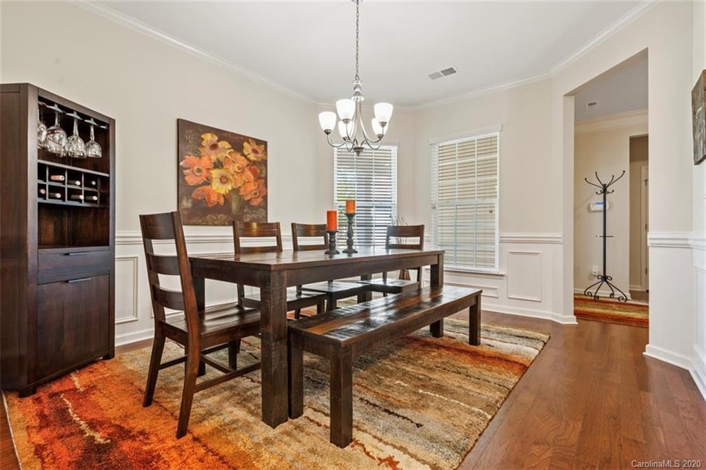 4303 Perth Road Indian Land, SC 29707 - Photo 21 of 32 a view of a dining room with furniture wooden floor and a chandelier