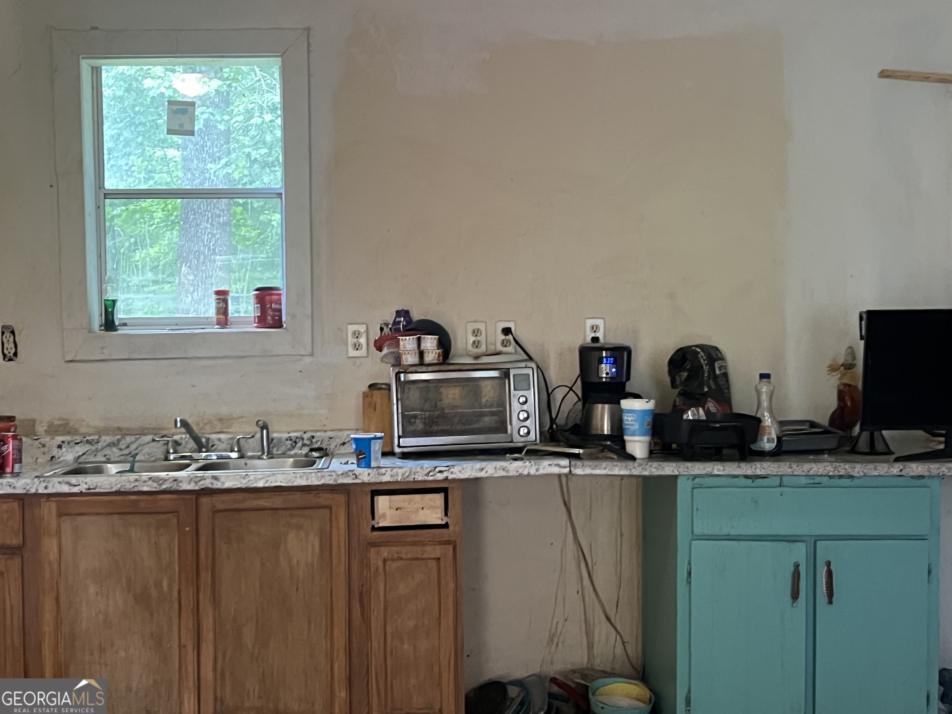 318 North Street Thomaston, GA 30286 - Photo 3 of 9 a kitchen with sink a microwave and cabinets