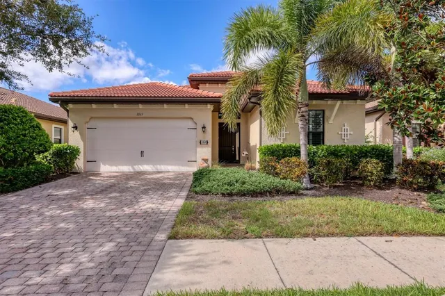 a front view of house with yard and tress