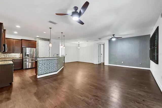 a view of a kitchen with a sink and a refrigerator