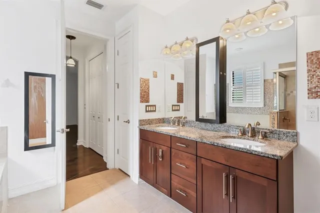 a spacious bathroom with a granite countertop sink mirror and a