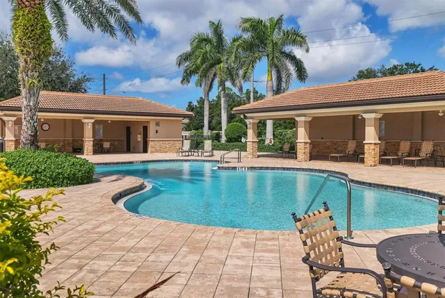 a view of a house with pool porch and sitting area