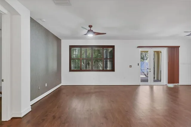 wooden floor in an empty room with a window