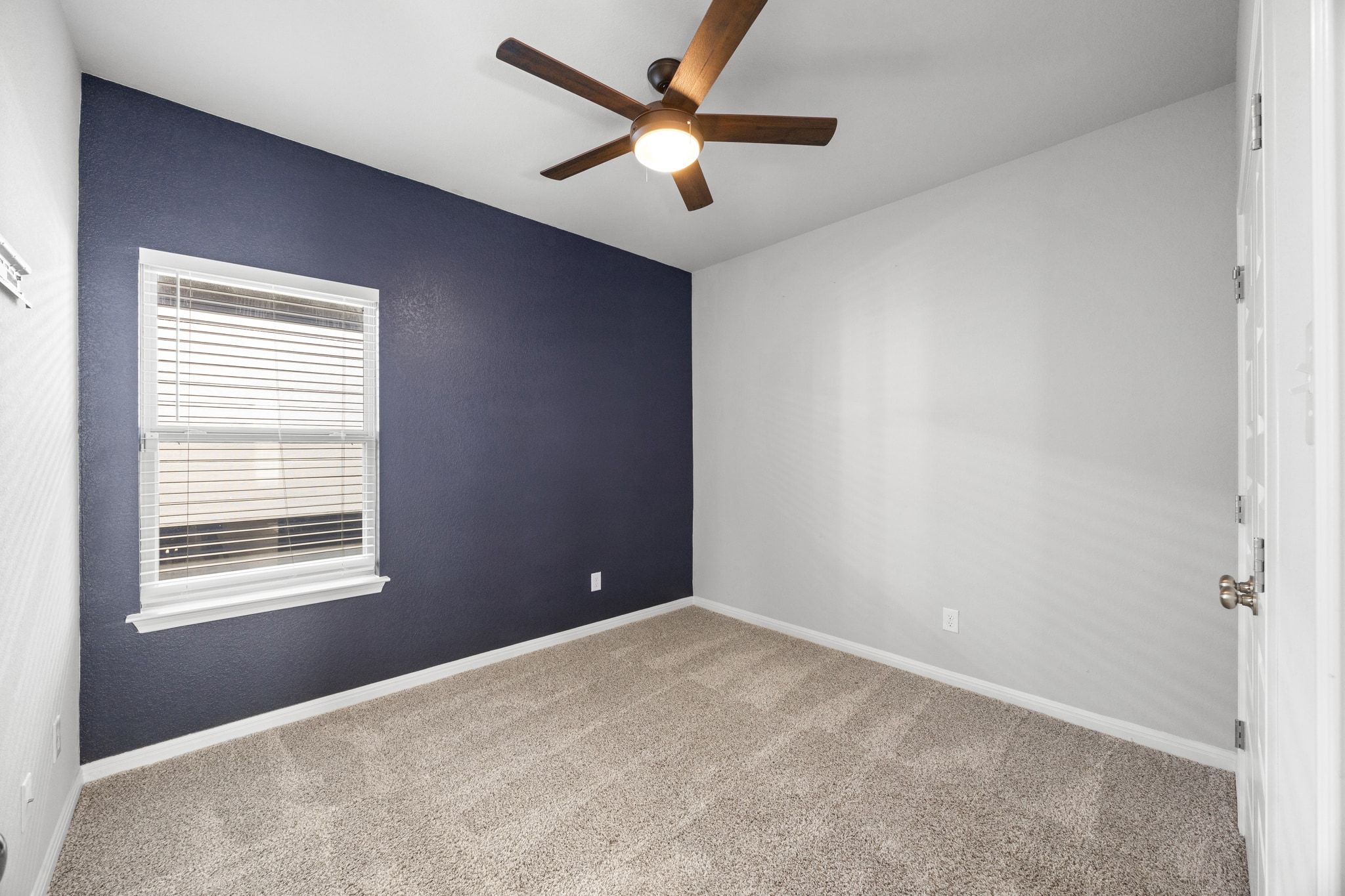 225 Unforgiven Lane Jarrell, TX 76537 - Photo 23 of 30 Spare room with light colored carpet and a ceiling fan
