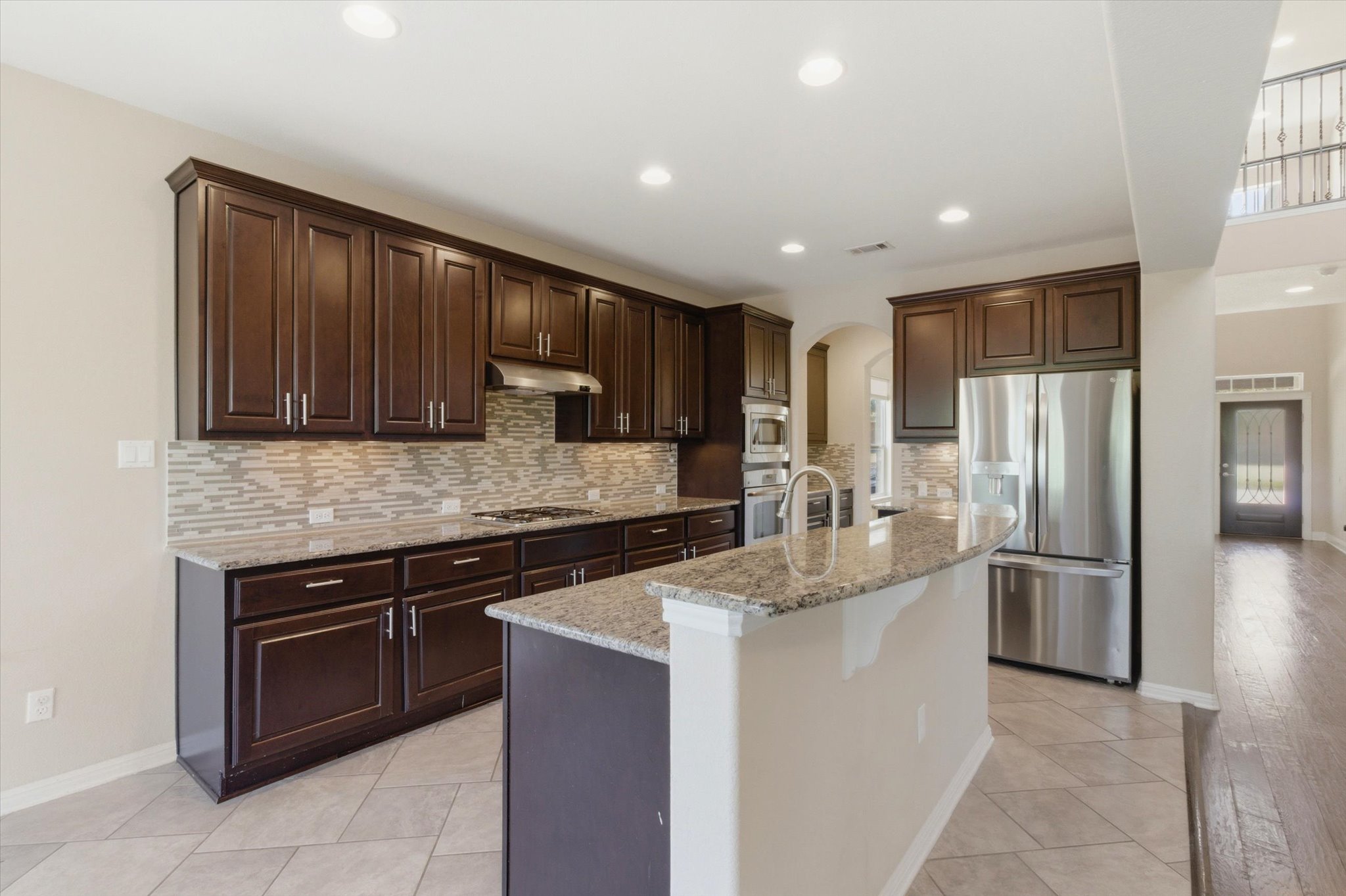 1511 Rimstone Drive Cedar Park, TX 78613 - Photo 9 of 39 An inviting kitchen, with dark wood cabinetry and granite countertops, sets the stage for culinary creativity.