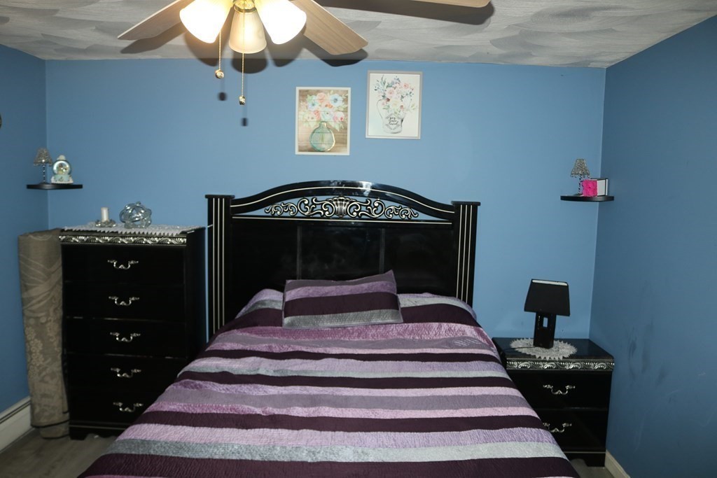 6 Shawnee Road Worcester, MA 01606 - Photo 14 of 39 a bedroom with a bed and a chandelier