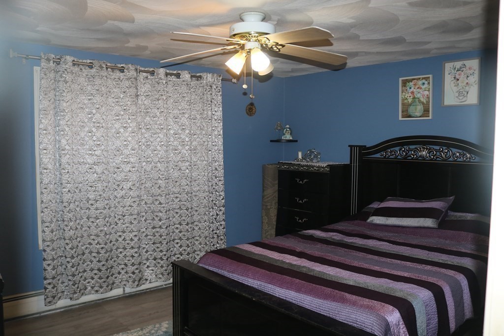 6 Shawnee Road Worcester, MA 01606 - Photo 15 of 39 a bedroom with a bed and a chandelier