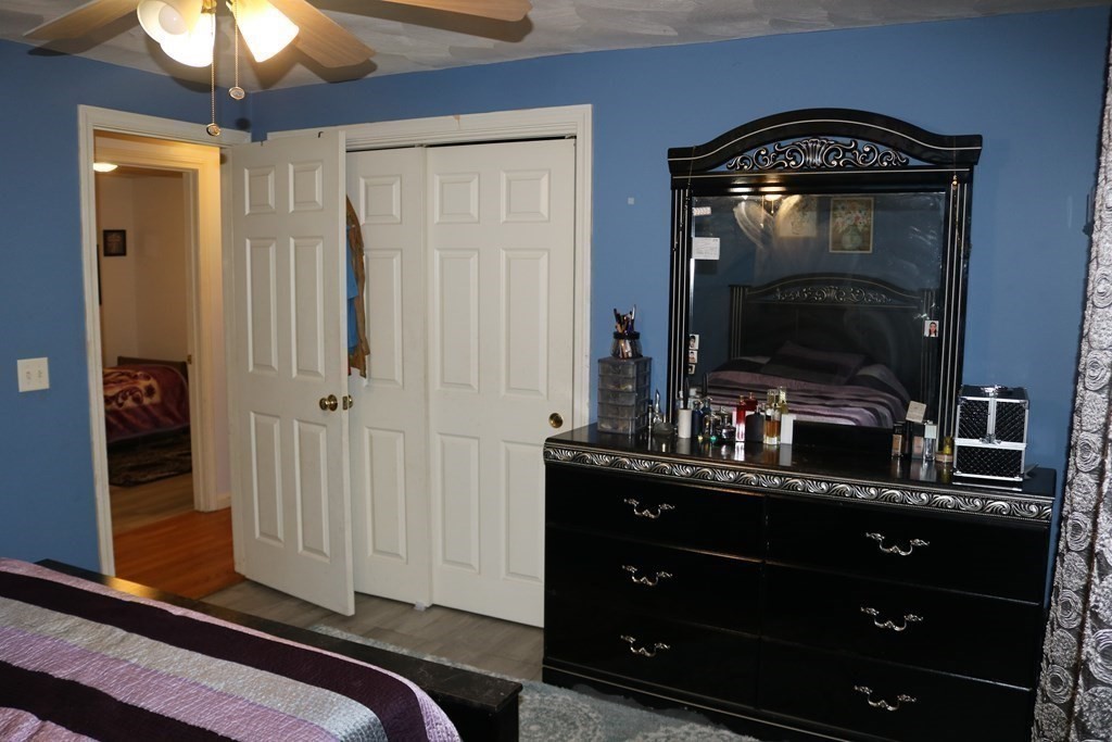 6 Shawnee Road Worcester, MA 01606 - Photo 17 of 39 a living room with a bed and a mirror on dresser