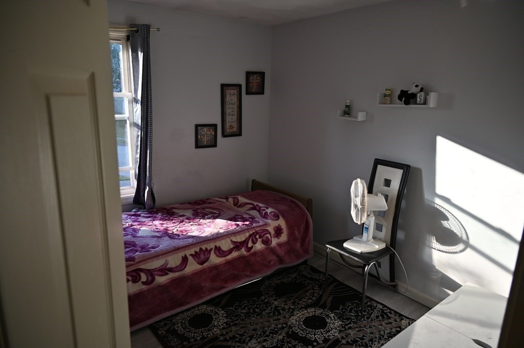 6 Shawnee Road Worcester, MA 01606 - Photo 18 of 39 a bedroom with a bed and wooden floor