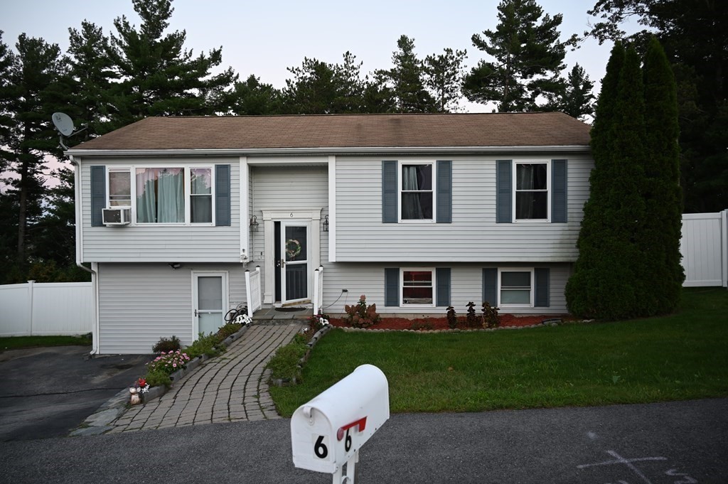6 Shawnee Road Worcester, MA 01606 - Photo 2 of 39 a front view of a house with a yard fire pit and trees in the background