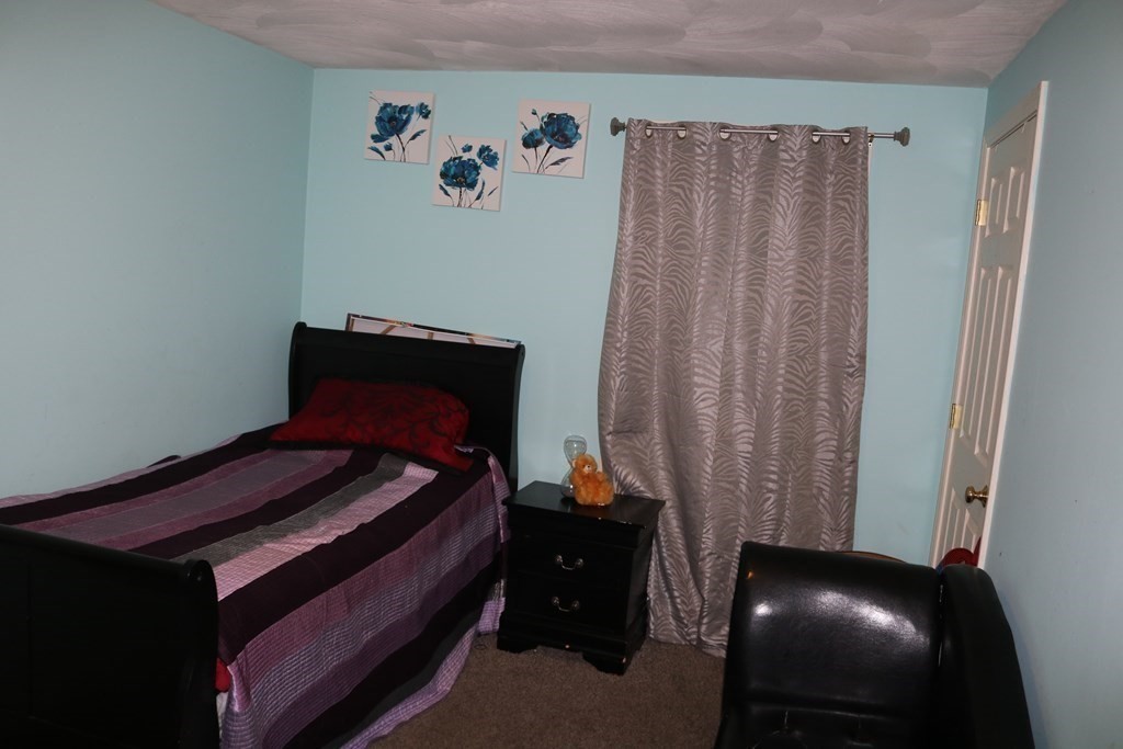 6 Shawnee Road Worcester, MA 01606 - Photo 21 of 39 a bed sitting in a bedroom next to a window