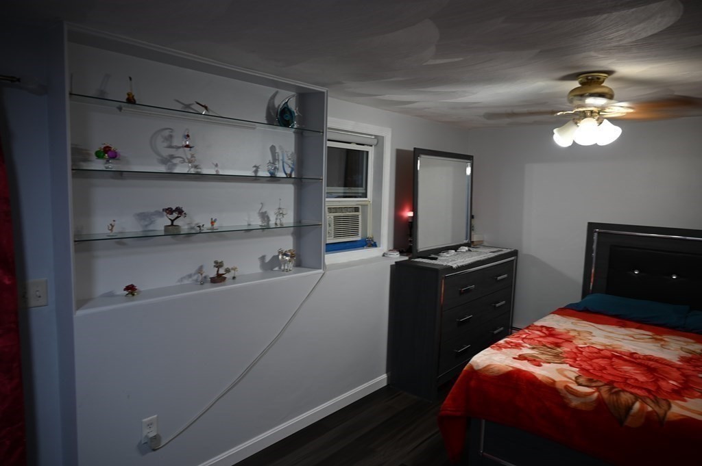 6 Shawnee Road Worcester, MA 01606 - Photo 27 of 39 a bedroom with a bed and a chandelier