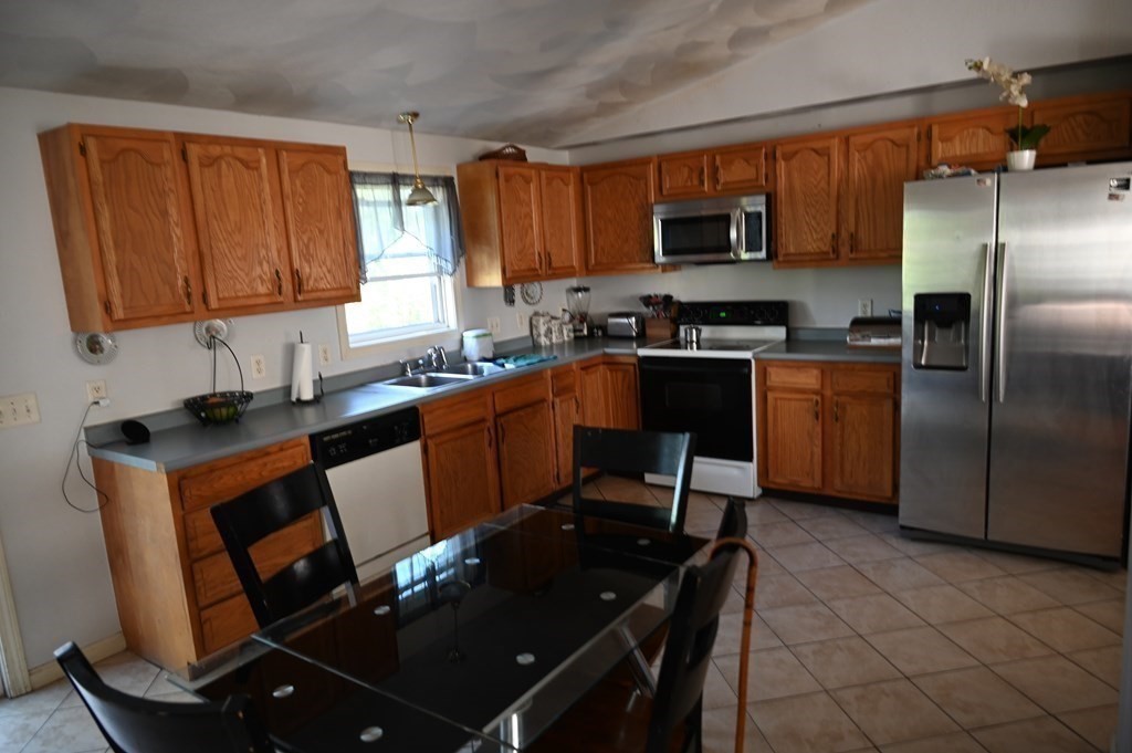 6 Shawnee Road Worcester, MA 01606 - Photo 9 of 39 a kitchen with granite countertop a refrigerator stove top oven and sink