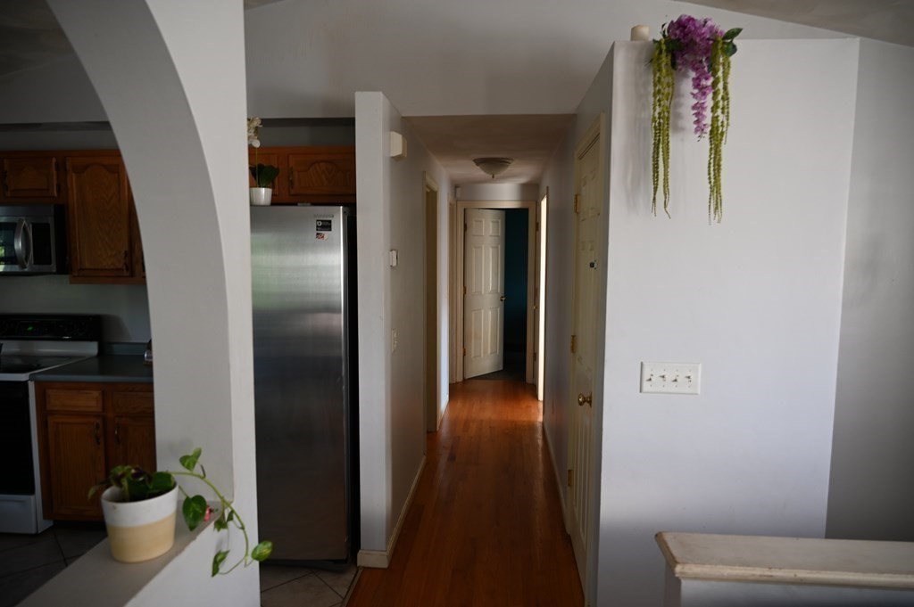 6 Shawnee Road Worcester, MA 01606 - Photo 10 of 39 a view of a hallway with wooden floor and living room