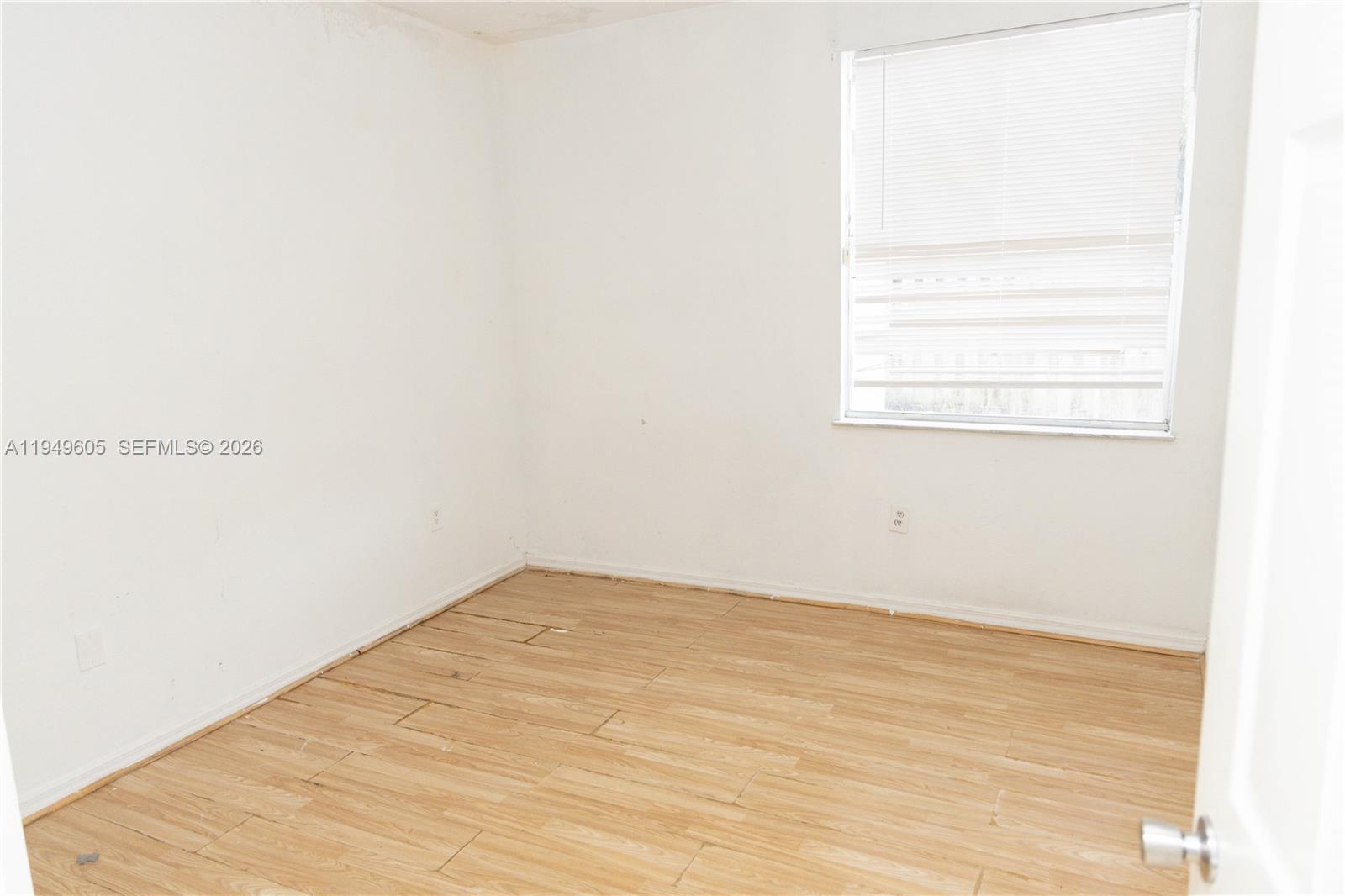 761 Southeast 2nd Street Homestead, FL 33030 - Photo 5 of 17 a view of a small space with wooden floor and a window