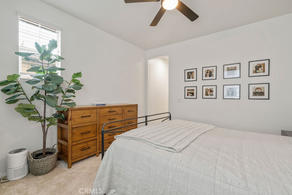 18 Garrison Loop, Unit 84 Ladera Ranch, CA 92694 - Photo 26 of 41 a bedroom with a large bed and a potted plant