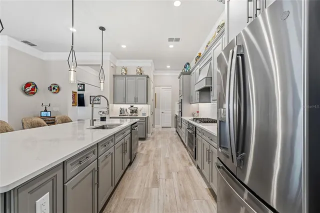 a kitchen with granite countertop cabinets stainless steel appliances and wooden floor