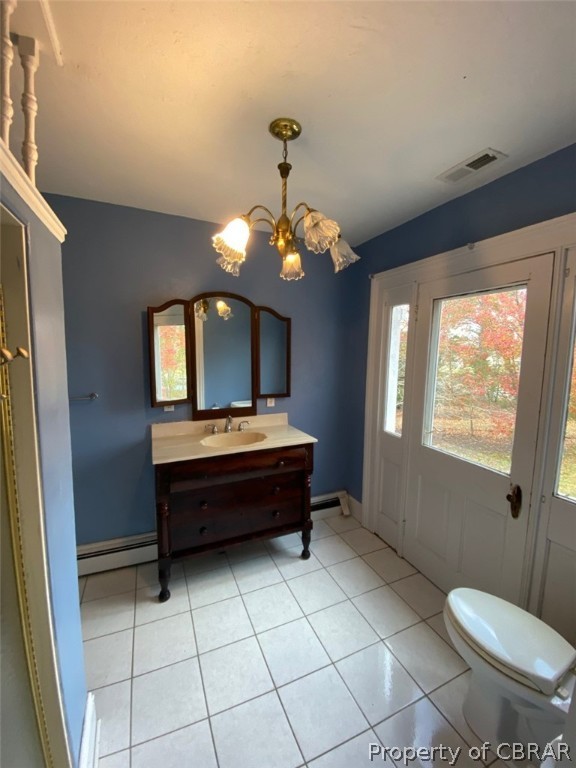 11044 Buckley Hall Road Mathews, VA 23109 - Photo 21 of 34 a spacious bathroom with a toilet a sink and mirror
