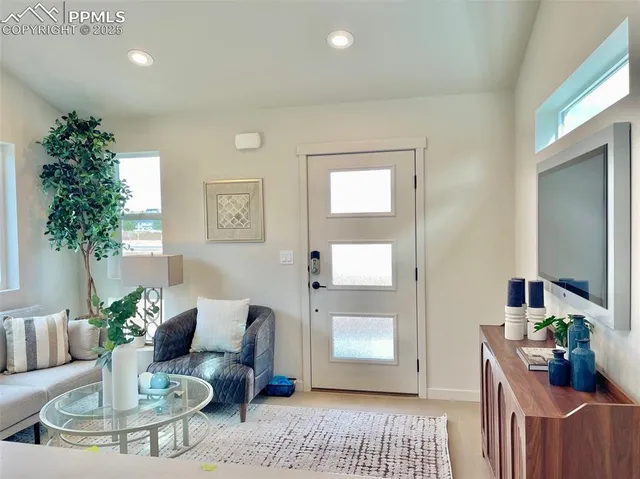 a living room with furniture and a potted plant