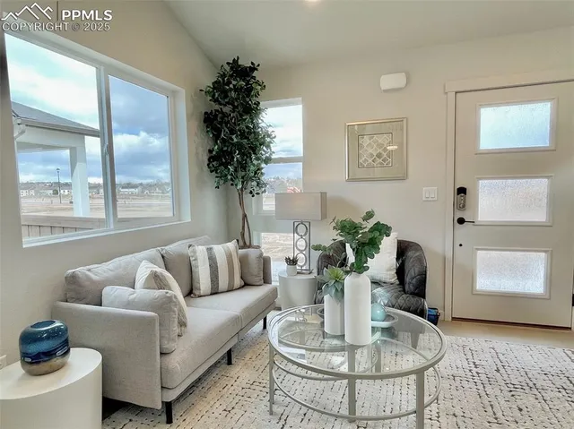 a dining room with furniture entryway and wooden floor