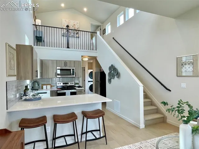 a kitchen with a sink stove and cabinets